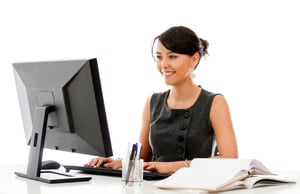 Businesswoman at the office working on a computer - isolated